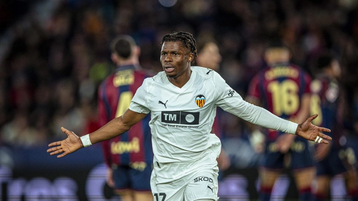 <p>Largie Ramazani celebrates a goal scored with Valencia</p>